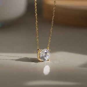 Macro shot of a minimalist S925 silver necklace with a brilliant round zircon in 4-prong setting