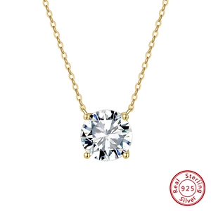 Detail of 925 sterling silver four-prong round zircon solitaire pendant on gold chain