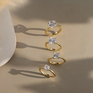 Set of four gold adjustable open rings featuring square princess cut zircon stones