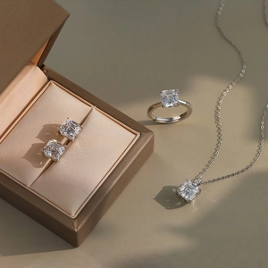 Macro detail of square-cut moissanite jewelry set with silver necklace and adjustable ring