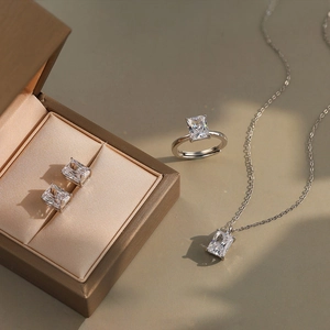 Macro shot of 925 sterling silver jewelry set featuring emerald-cut moissanite stones