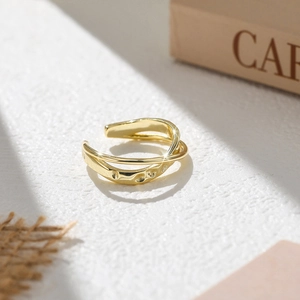 Nahaufnahme des goldenen Möbius-Rings mit Hammerschlag-Optik und Poliereffekt