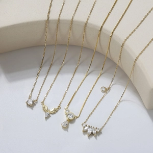 Detailed collection of five gold-plated S925 silver necklaces with zircon pendants on display