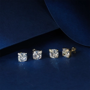 Detail of cushion-cut square zircon stud earrings with silver and gold leaf accents