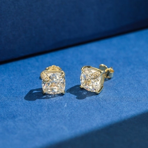 Detail of square-cut golden earrings with four-prong setting and side micro-diamonds