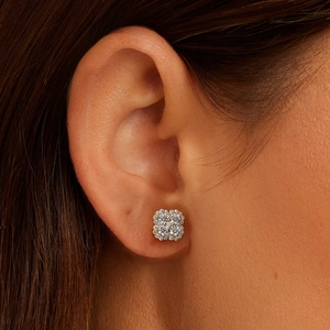 Macro shot of square cluster diamond stud earrings in gold setting worn on ear