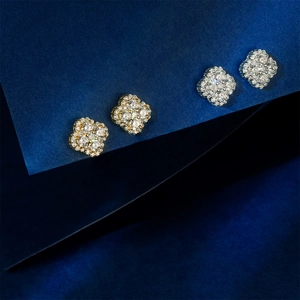 Elegant gold and silver four-leaf clover stud earrings with sparkling pavé cubic zirconia