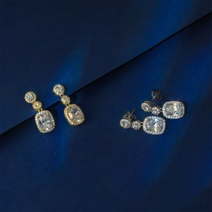 Elegant gold and silver pavé dangle earrings with cushion-cut stones and halo design