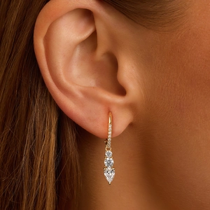 S925 silver teardrop zircon earrings with three-stone drop design on female model