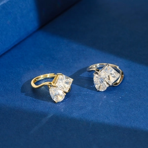 Adjustable S925 silver ring featuring pear and square cut synthetic diamonds on blue background