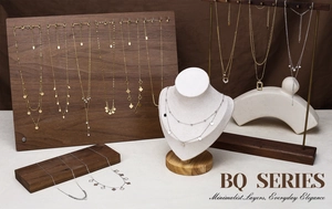 Detail view of BQ SERIES minimalist layered necklaces with pendants on jewelry stands