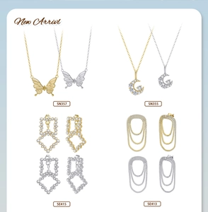 Detail view of gold and silver butterfly necklaces and sparkling zircon earrings