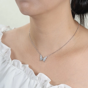 Close-up of S925 sterling silver butterfly pendant necklace worn by a female model