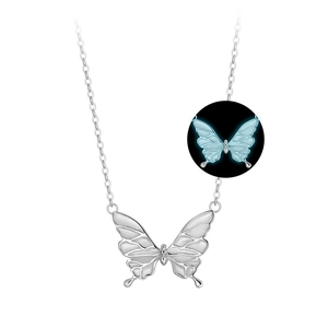 Elegant silver butterfly necklace with a glowing blue luminous effect in the dark
