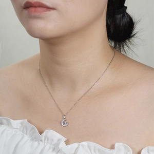 Silver moon pendant necklace with sparkling cubic zirconia on a female model