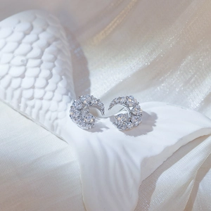 Detailed view of sterling silver crescent moon stud earrings with pavé set zircons