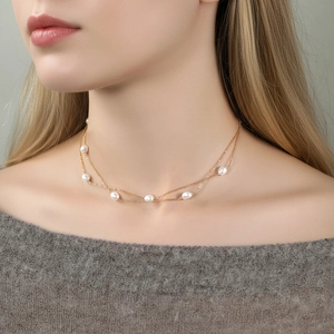 Elegant double-layered S925 silver gold pearl necklace on a female model