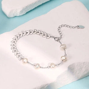 Elegant 925 sterling silver bracelet featuring pearls and leaf links on white stone