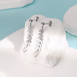 Detailed macro view of S925 sterling silver wheat leaf earrings with drop pearls