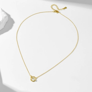 Macro detail of S925 sterling silver stamp on golden double interlocking ring necklace