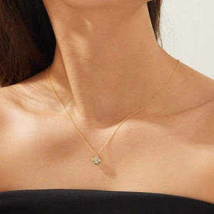 Elegant 925 sterling silver four-leaf clover pendant necklace with diamonds on a model