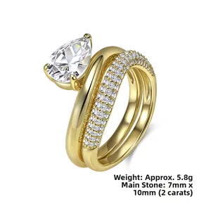 Detailed macro view of 2-carat pear cut zircon and gold plated stacking ring set