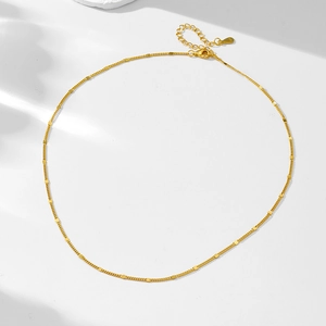 Macro detail of S925 sterling silver gold plated chain showing clasp and hallmark