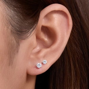 Elegant S925 sterling silver four-prong round zircon stud earrings worn on ear