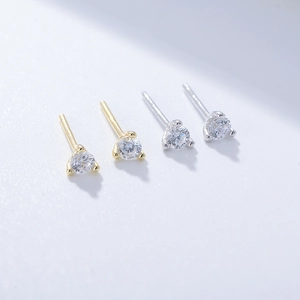 Close-up of gold and silver S925 sterling silver three-prong round zircon stud earrings