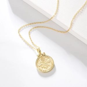 Close-up of S925 sterling silver stamp on golden Elizabeth coin relief pendant necklace