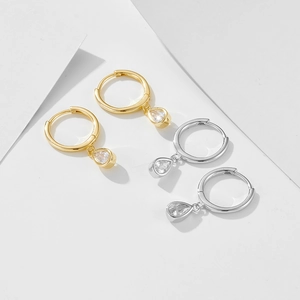 Detail of S925 sterling silver hoop earrings with teardrop zircon in gold and silver