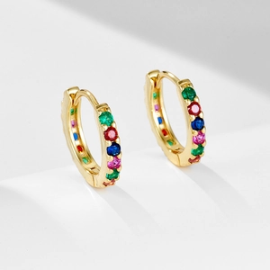 Macro shot of gold-plated S925 silver huggie earrings with colorful zircon stones