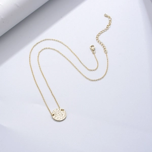 Minimalist S925 sterling silver gold coin necklace featuring a textured hammered pendant