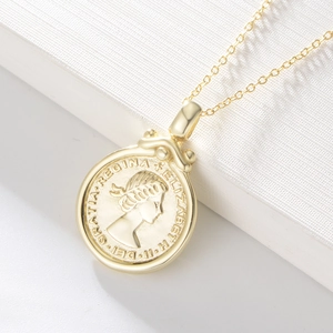 Macro shot of S925 silver Queen portrait coin pendant with vintage gold embossed finish