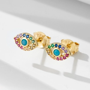 Macro detail of 925 sterling silver evil eye stud earring with colorful zircon stones