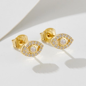 Detail of 925 sterling silver evil eye earrings with gold plating and cubic zirconia