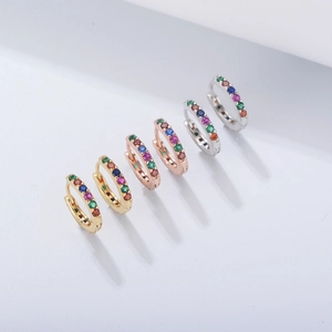 Detailed view of rainbow zircon hoop earrings in gold, rose gold, and silver finishes