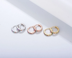 Detailed view of three pairs of S925 silver hoop earrings with multicolored zircons