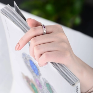Detail of s925 silver ring featuring micro-set white and purple square zircons on model