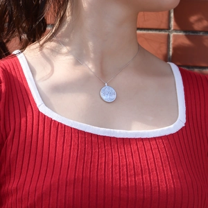 Sterling silver Tree of Life necklace with natural shell pendant on a model
