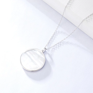 Close-up of s925 silver Tree of Life necklace with a white mother of pearl shell pendant