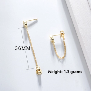 Macro detail of S925 silver 18K gold chain earrings with 36mm length and zircon studs