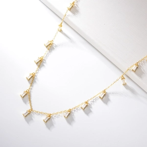 Detail of s925 silver fringe necklace with square zircon pendants on a white background