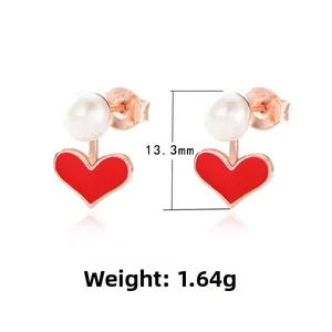 Macro view of S925 silver heart stud earrings with red enamel and white pearls
