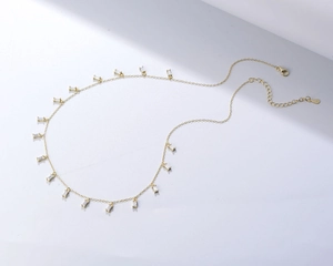 Macro shot of S925 silver gold-plated necklace with baguette-cut zircon pendants