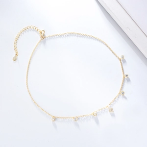 Macro view of gold s925 silver choker chain with zircon pendants and drop-shaped tail extension