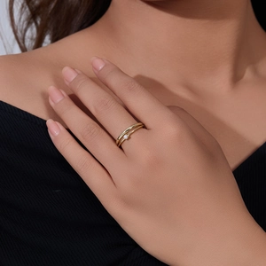 Detailed close-up of a delicate gold S925 silver double-layered pearl ring on a finger