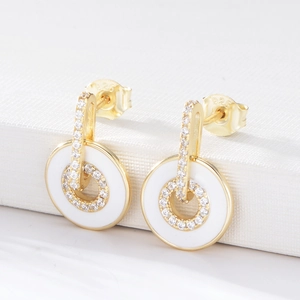 Macro shot of S925 sterling silver stamp on golden enamel earrings with cubic zirconia