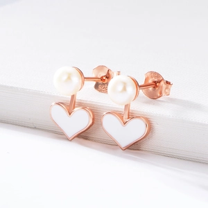 Macro shot of S925 sterling silver stamp on heart pearl earrings with rose gold finish