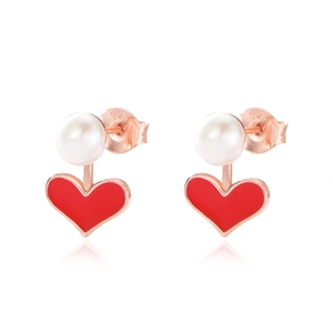 Detail of 925 silver rose gold heart earrings with white pearls and red enamel